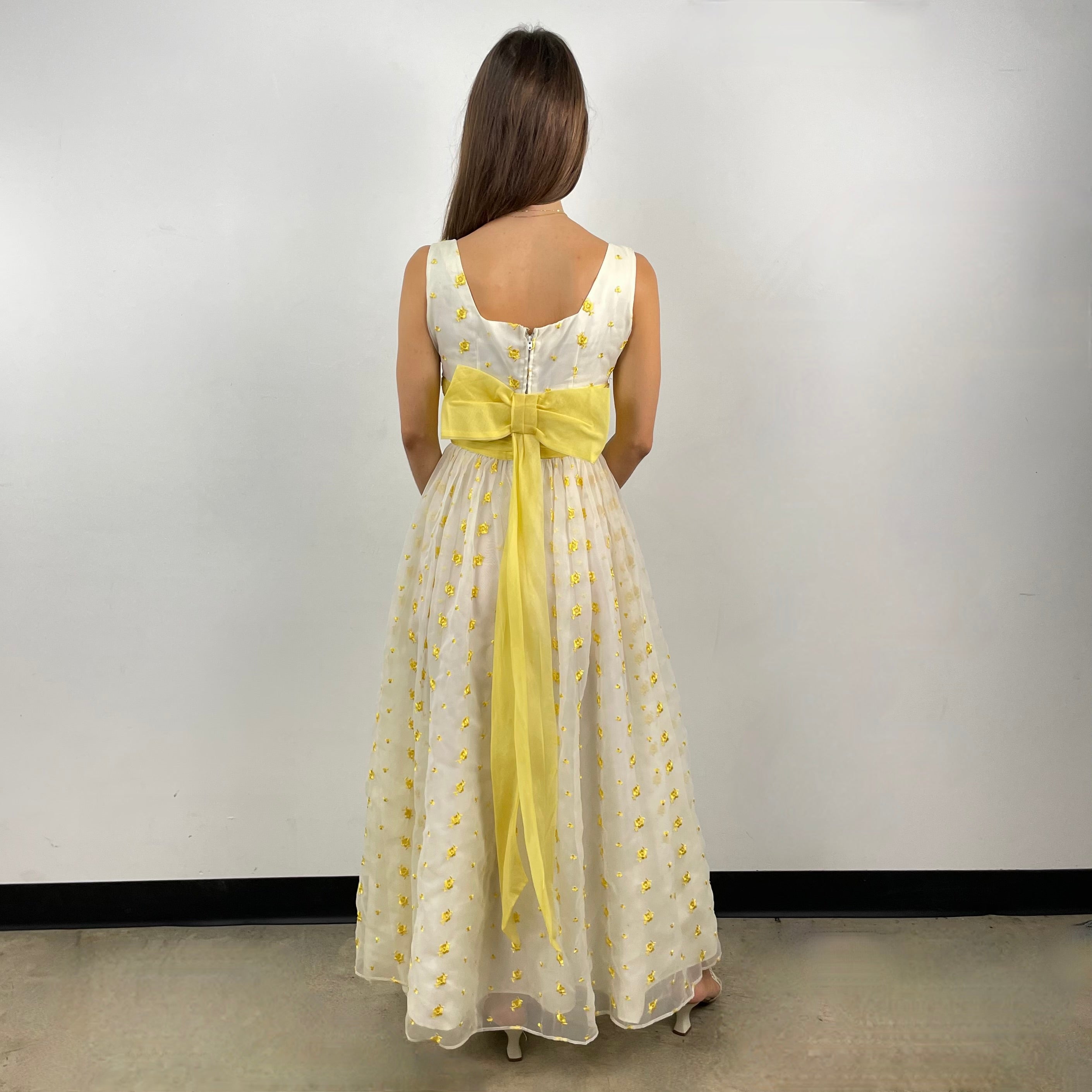 Boheme Vintage 1960s deadstock chiffon gown with yellow floral embroidery, square neckline, and oversized back bow.
