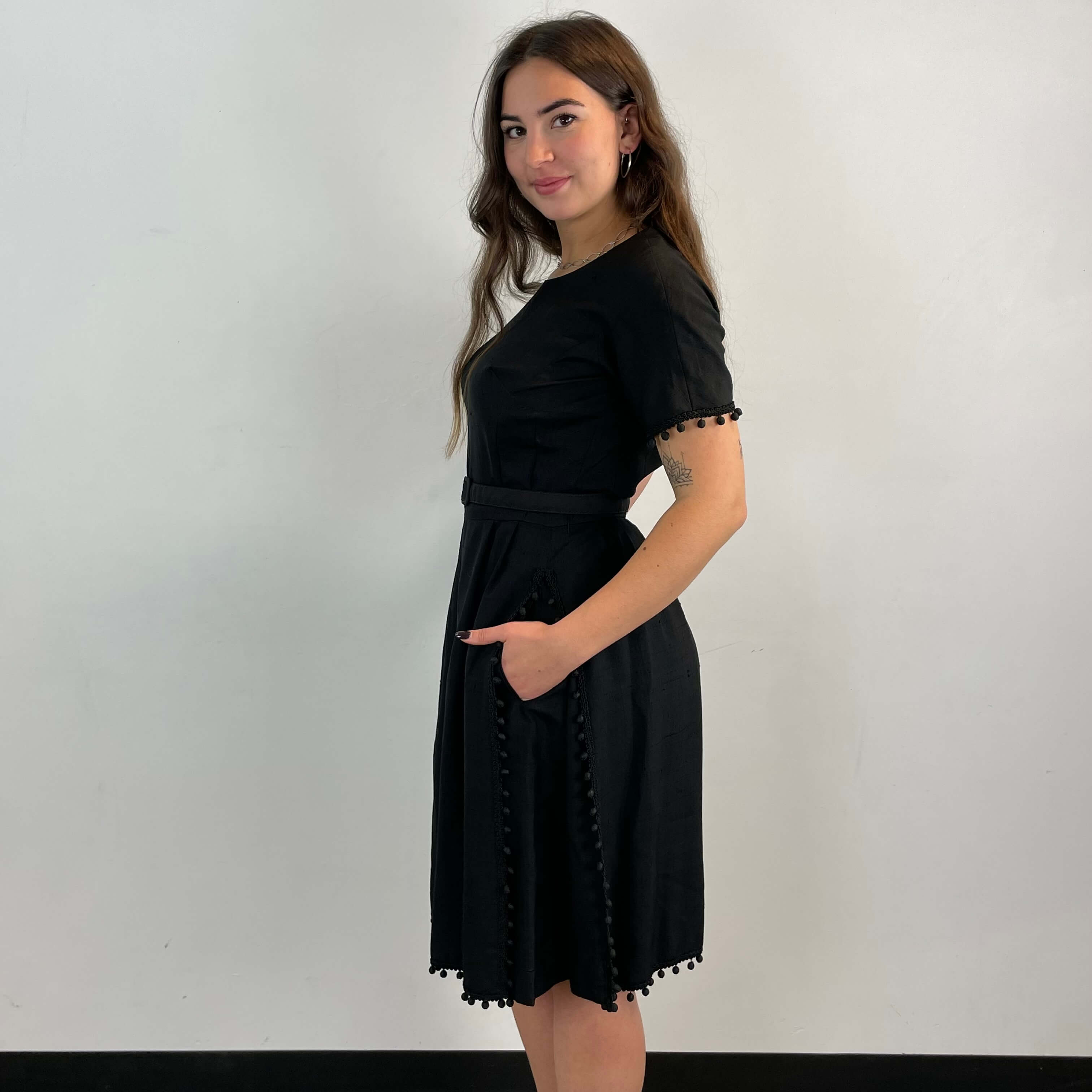 Side view of 1950s Black Short-Sleeve Cocktail Dress size medium sold at bohemevintage.com Montreal