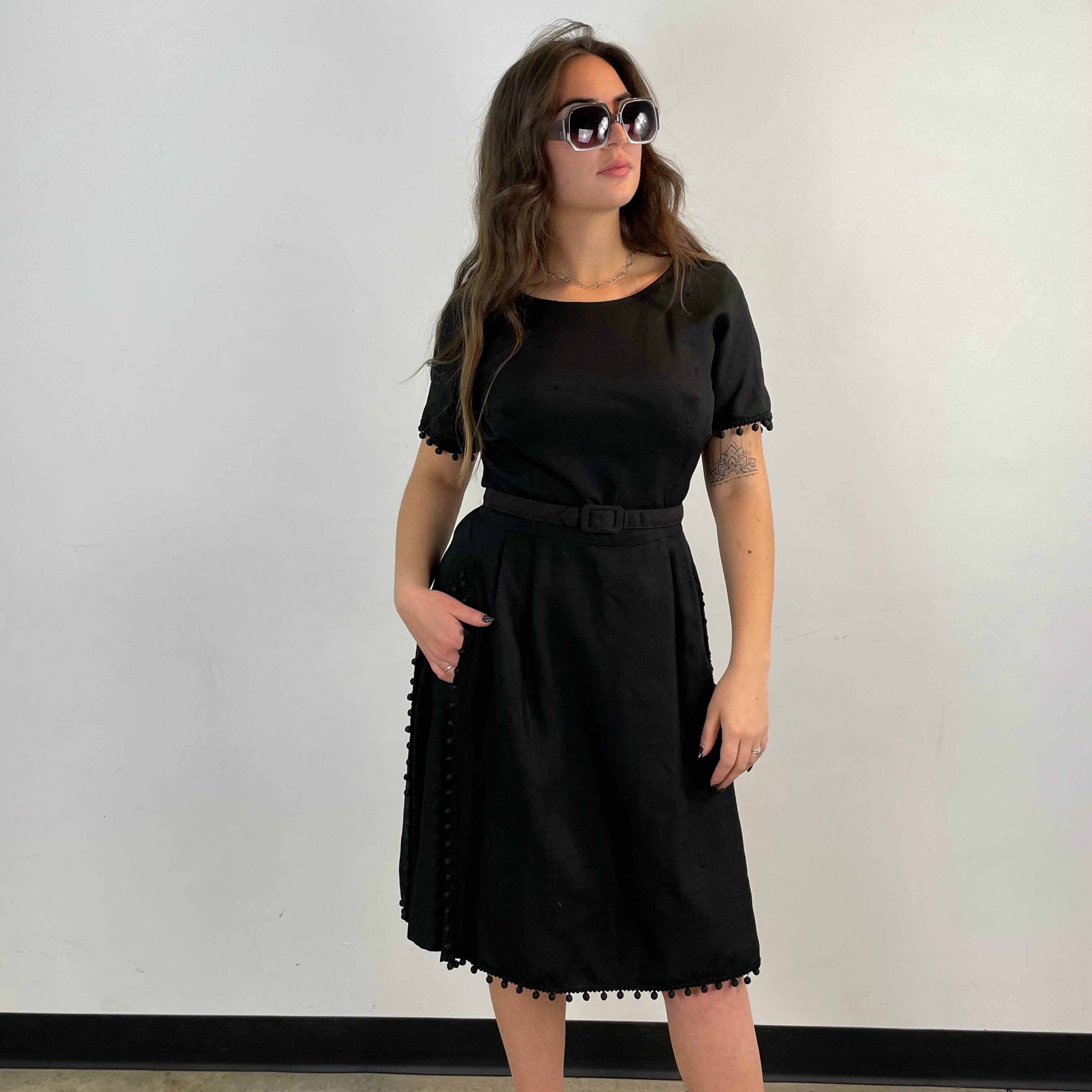 Front view of 1950s Black Short-Sleeve Cocktail Dress size medium sold at bohemevintage.com Montreal