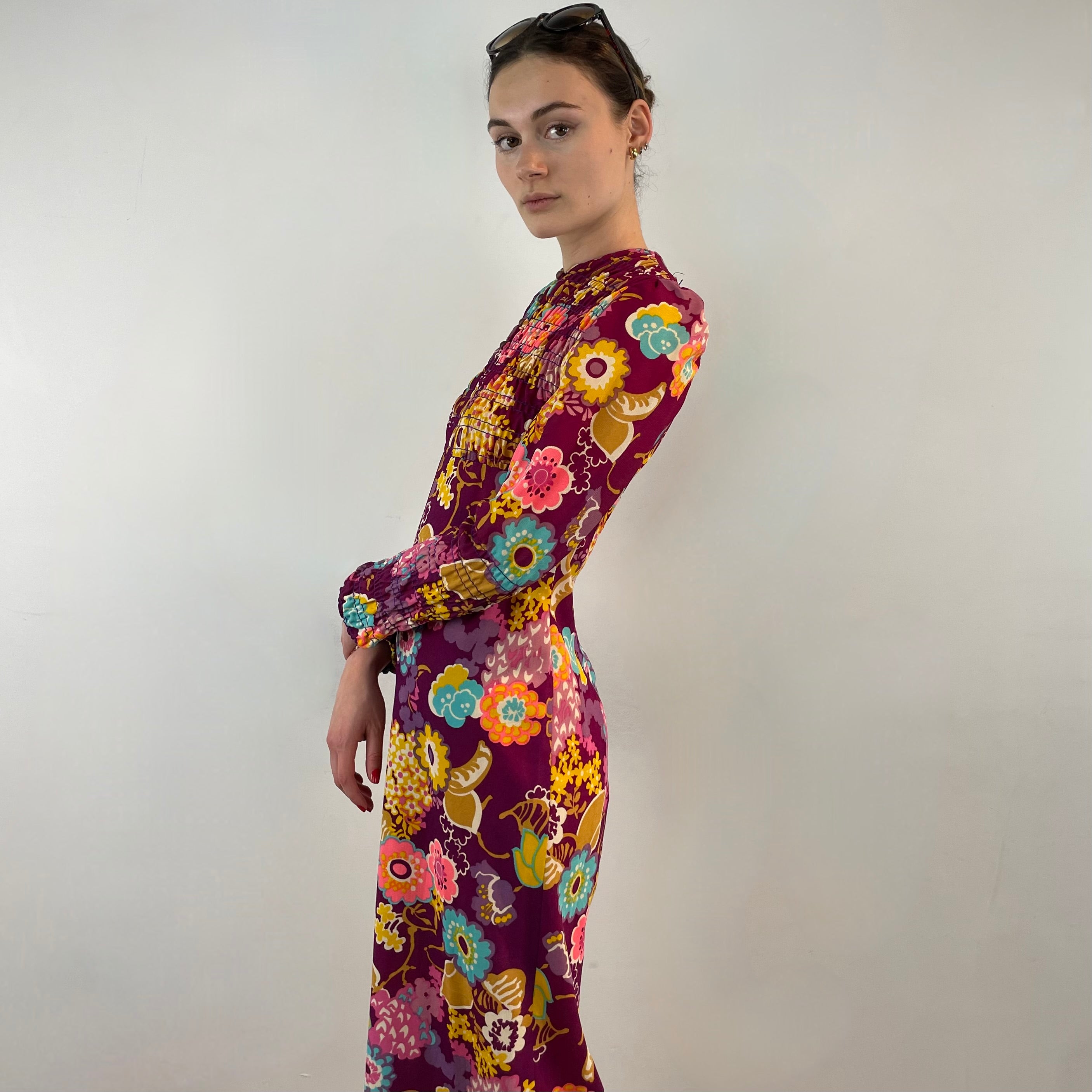 Side view of 1970s floral empire waist maxi dress with ruched bodice, high neckline and long ruched sleeves in bold print lightweight fabric – Boheme Vintage Montreal https://bohemevintage.com