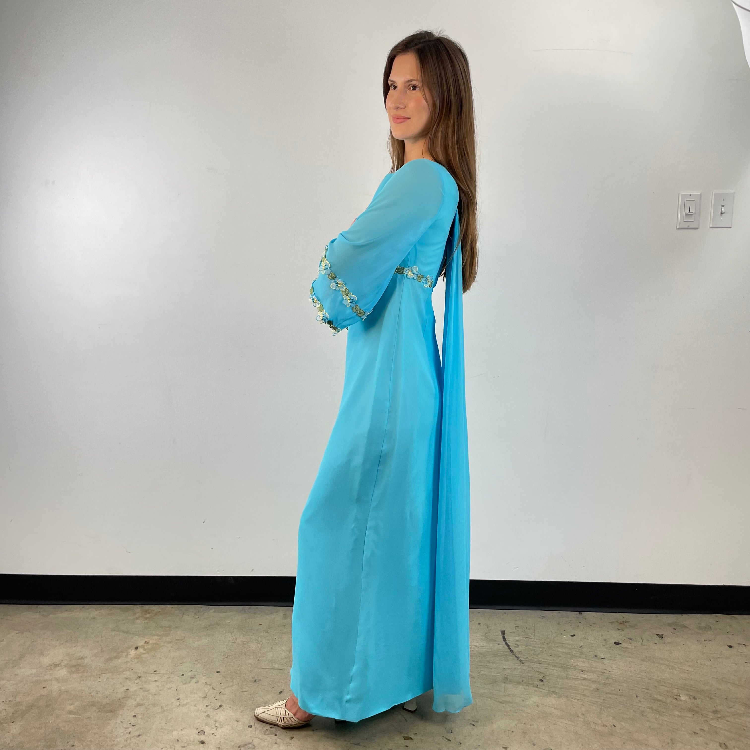 Side view of 1970s Turquoise Silk Chiffon Long-Sleeved Maxi Dress Small sold on bohemevintage.com Montreal