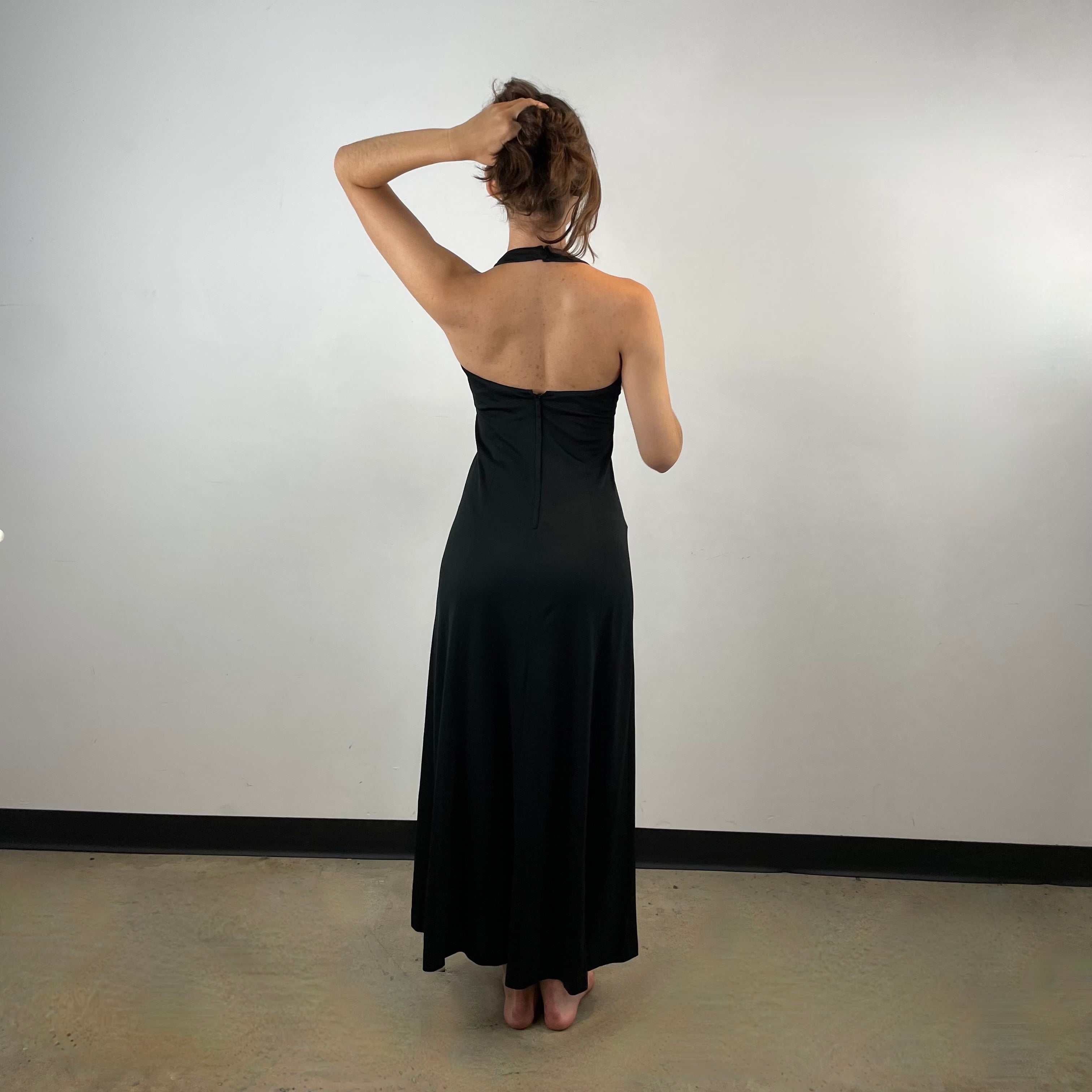 Back View of Boheme Vintage 1970s handmade black halter maxi dress with empire waist and patterned bust.