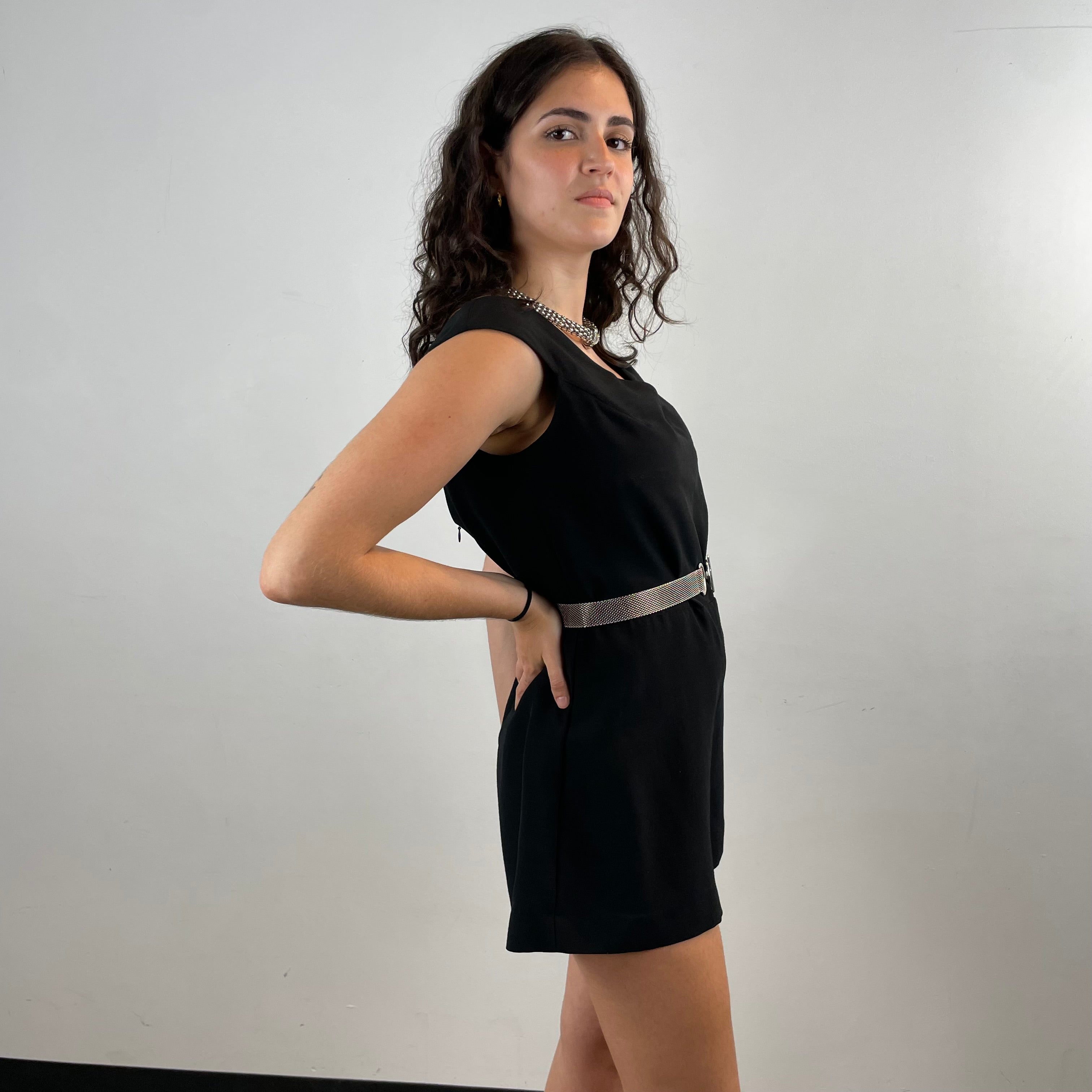 Side View of Boheme Vintage 1980s C’est Ma Mère Qui M’habille black romper with deep V neckline and flared shorts.