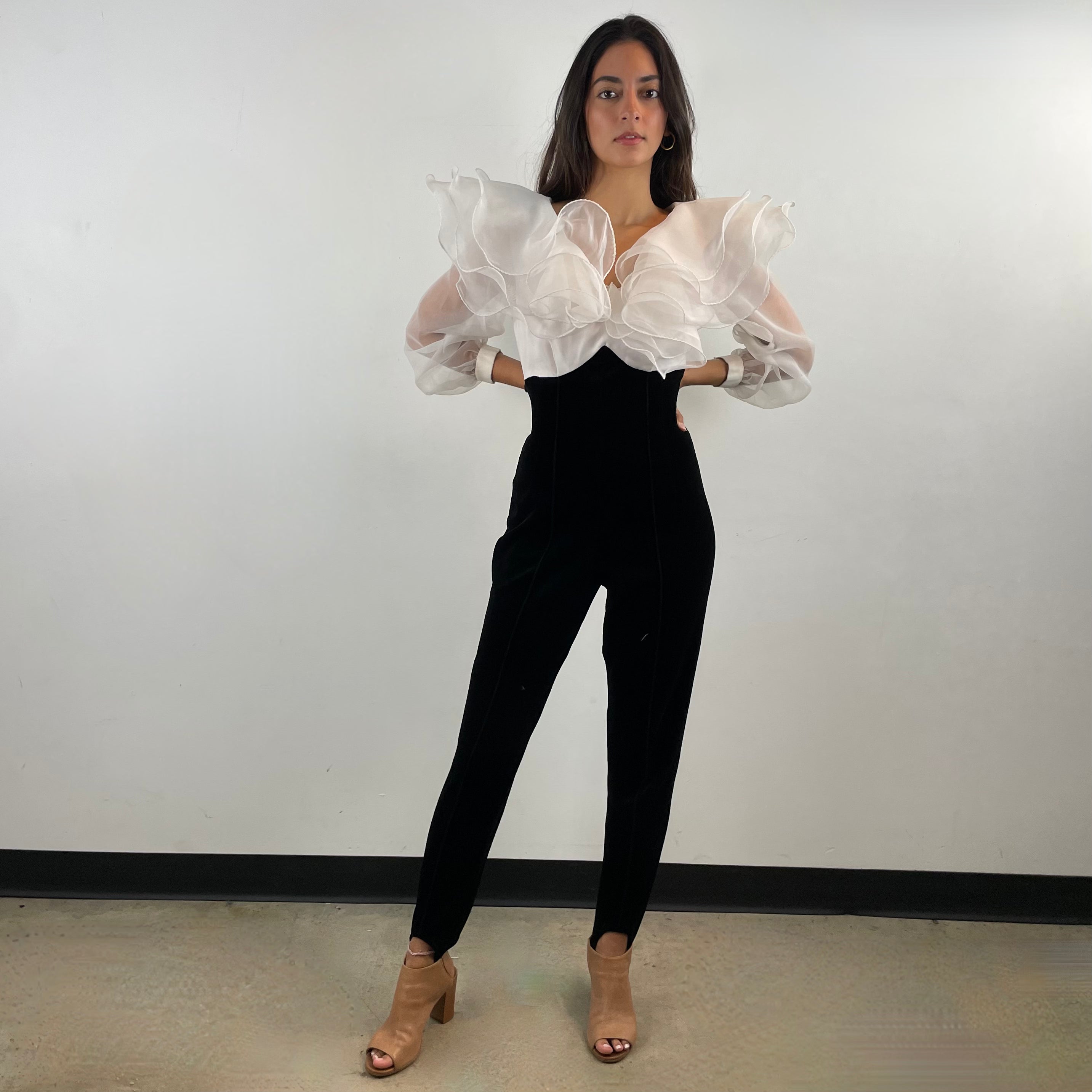 Front view of 1980s Ruffle Collar Stirrup Jumpsuit
Size Small
Sold at bohemevintage.com Montréal