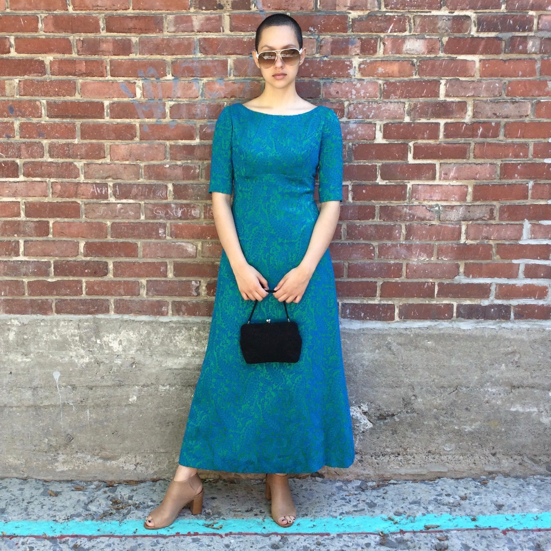 Vintage 1960s blue and green brocade ankle-length evening dress with empire waist and low back detail, photographed in Montreal for Boheme Vintage – https://bohemevintage.com
– Montreal vintage fashion boutique.