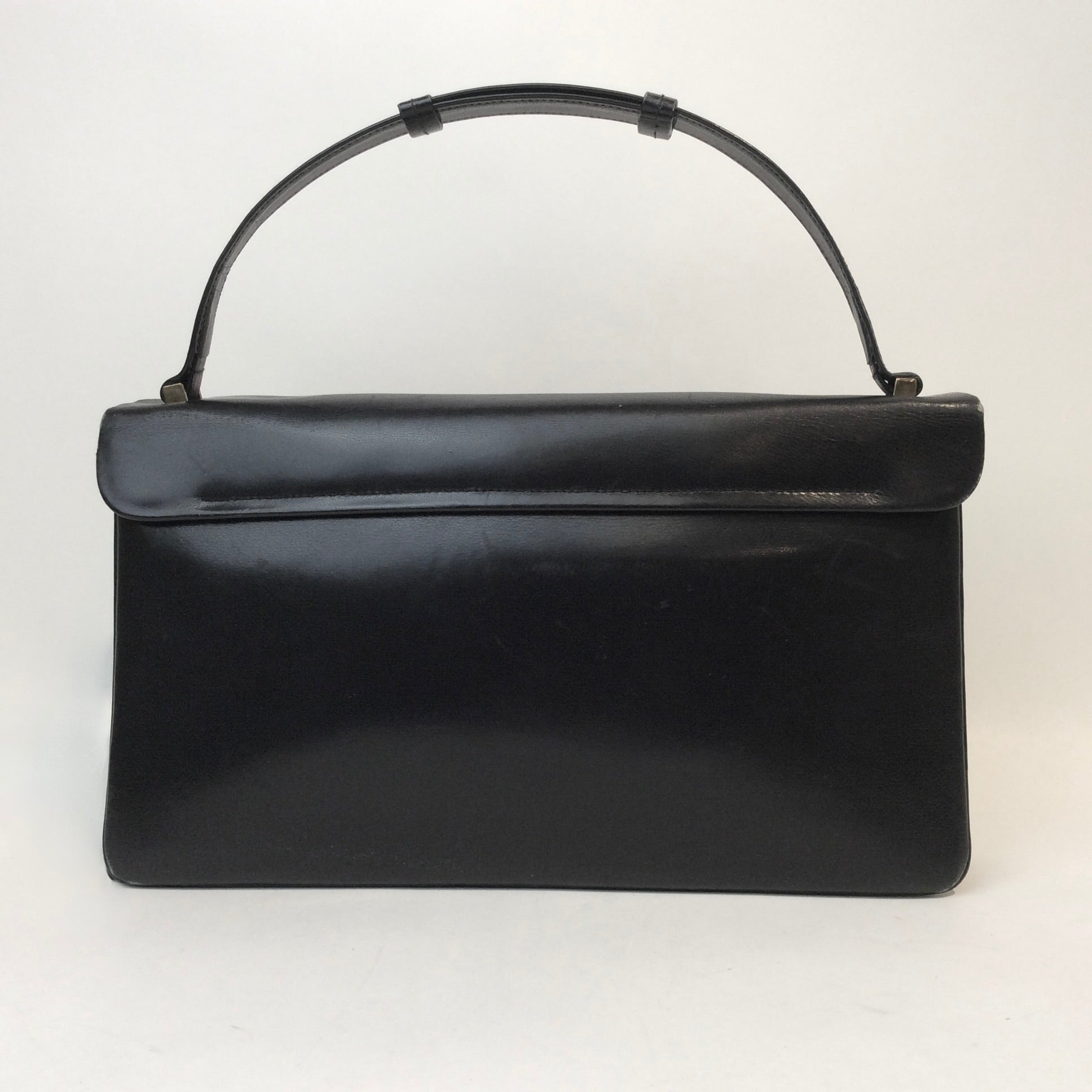 Vintage Art Deco leather handbag with unique closure and gold-tone hardware, available at Boheme Vintage, Montreal — bohemevintage.com