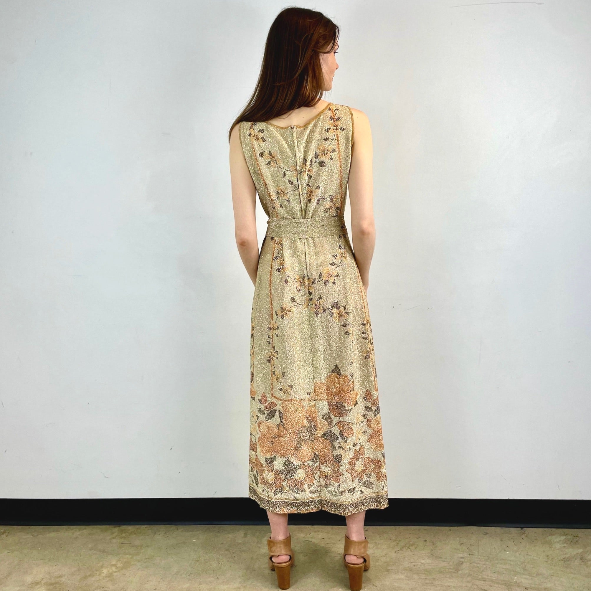 Boheme Vintage 1970s Le Petit Salon Dupuis gold Lurex maxi dress with sheer brocade fabric, sleeveless silhouette, and belt.