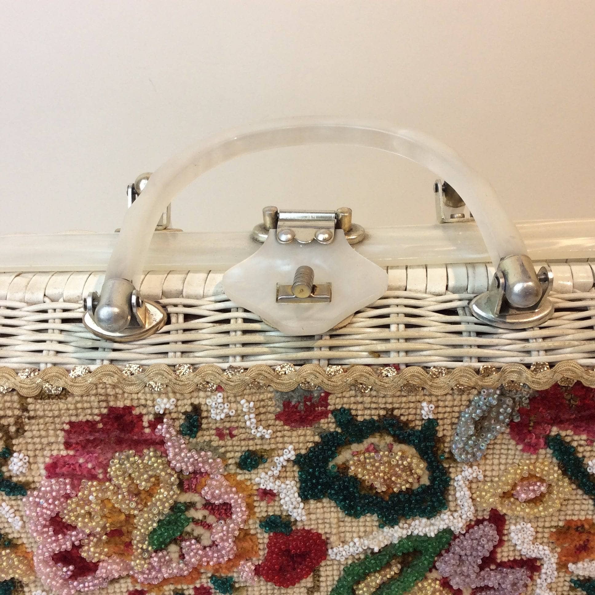 Needlepoint and handle detail of 1950s-60s Floral Needlepoint Wicker Basket Purse sold by bohemevintage.com Montreal