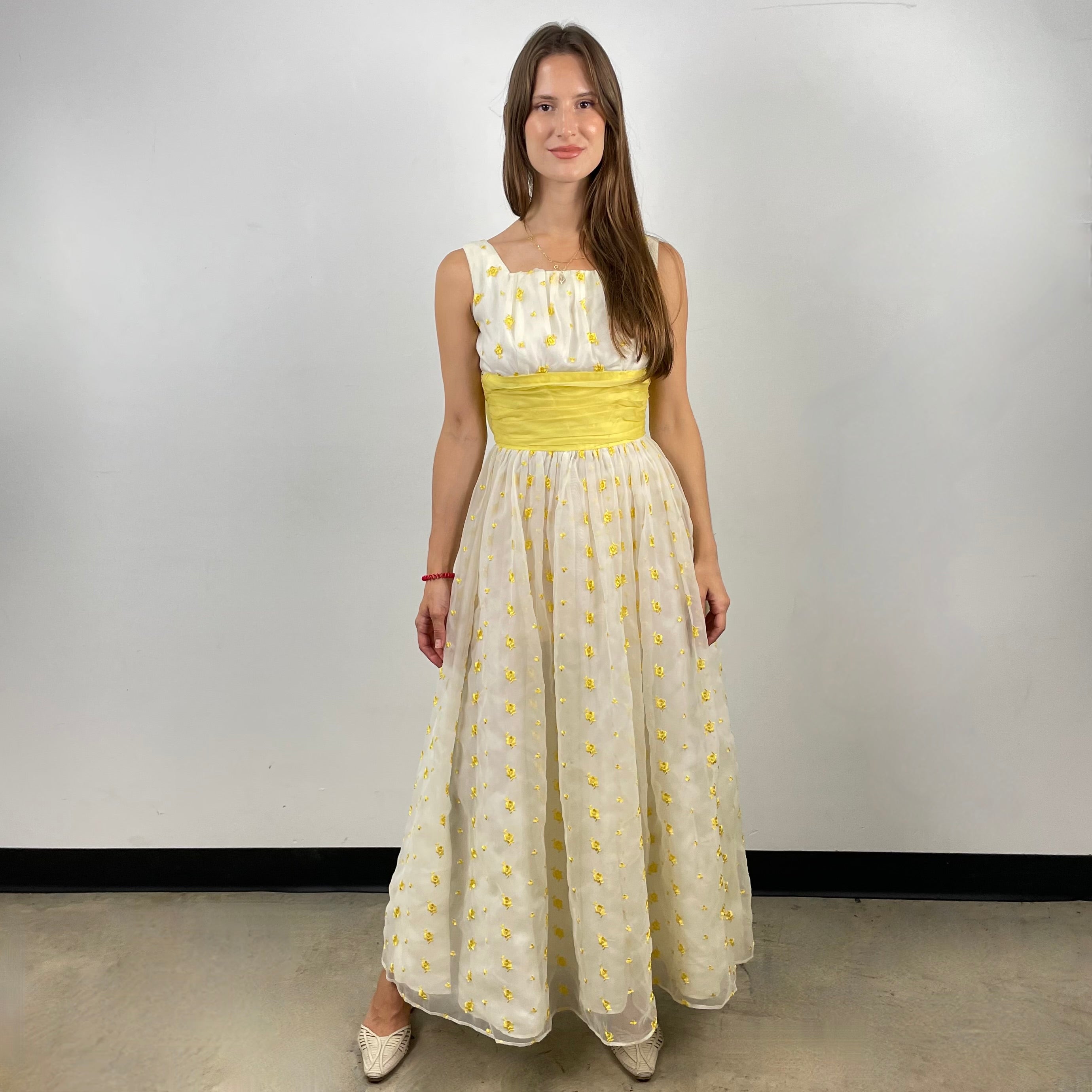 Boheme Vintage 1960s deadstock chiffon gown with yellow floral embroidery, square neckline, and oversized back bow.