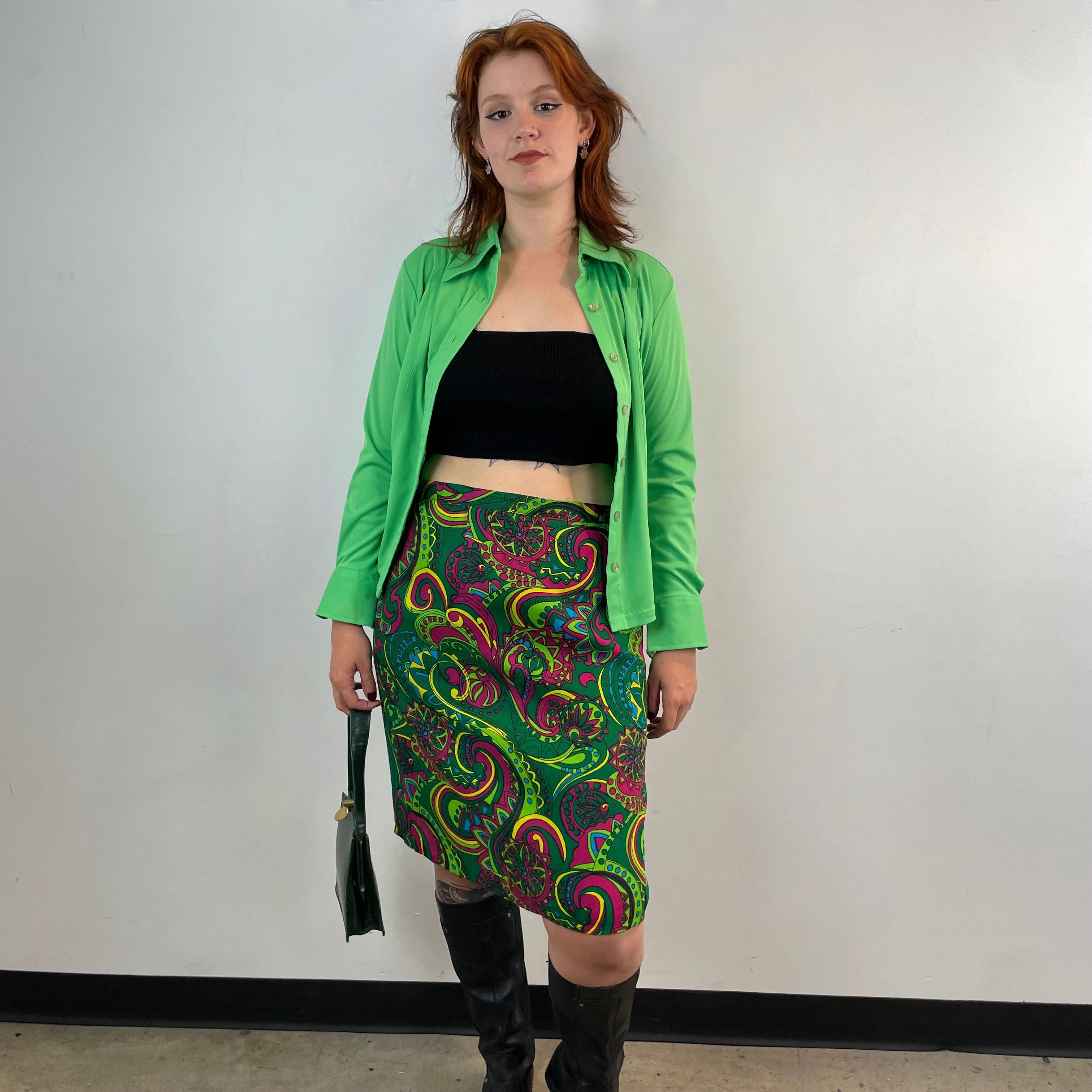 Vintage 1960s handmade skirt with a bold colorful psychedelic paisley print, straight cut, fitted hips, acetate lining and side metal zipper.