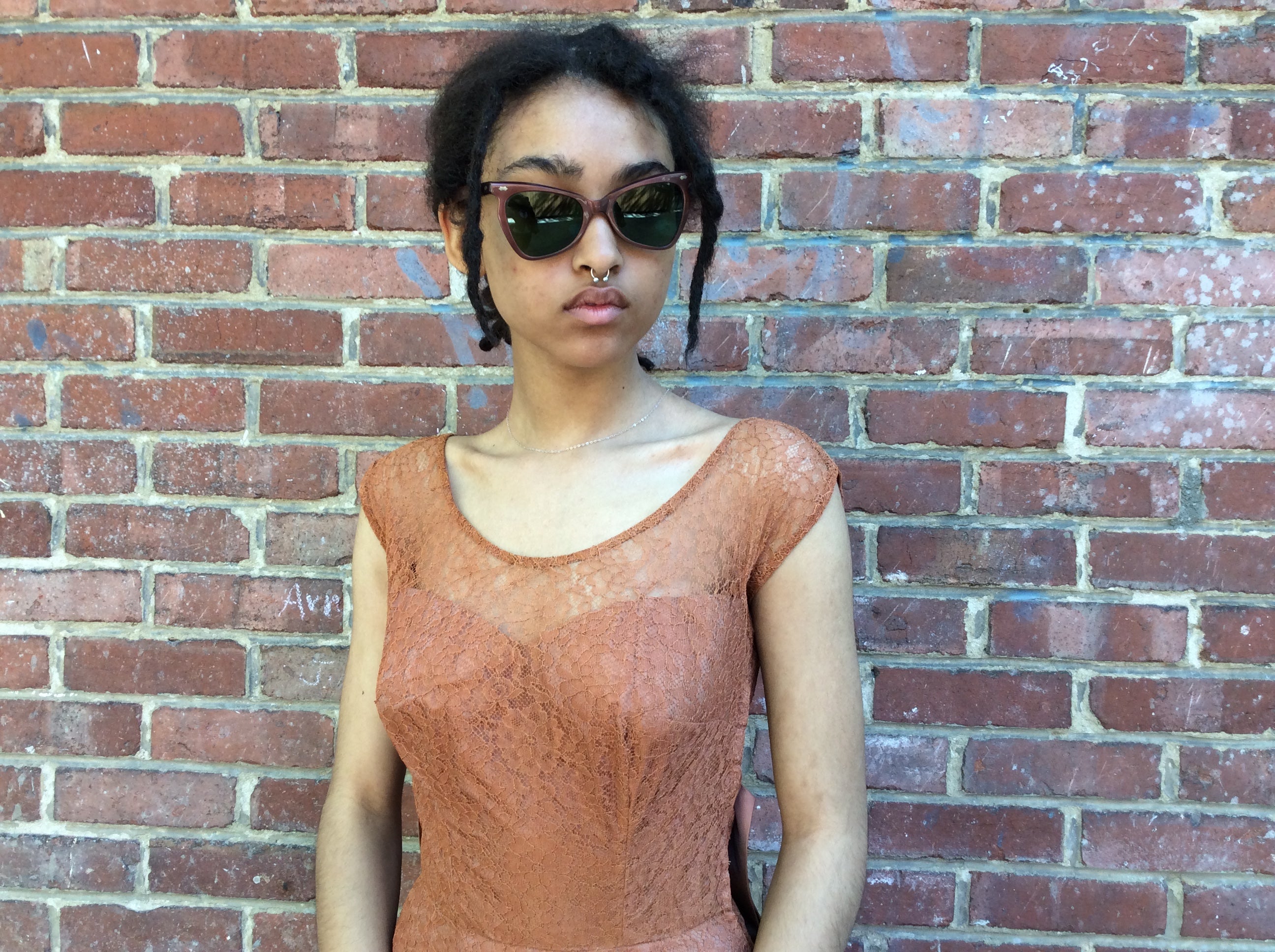 Boheme Vintage 1980s lace cocktail dress with bustier bodice, sheer overlay, and oversized bow detail.