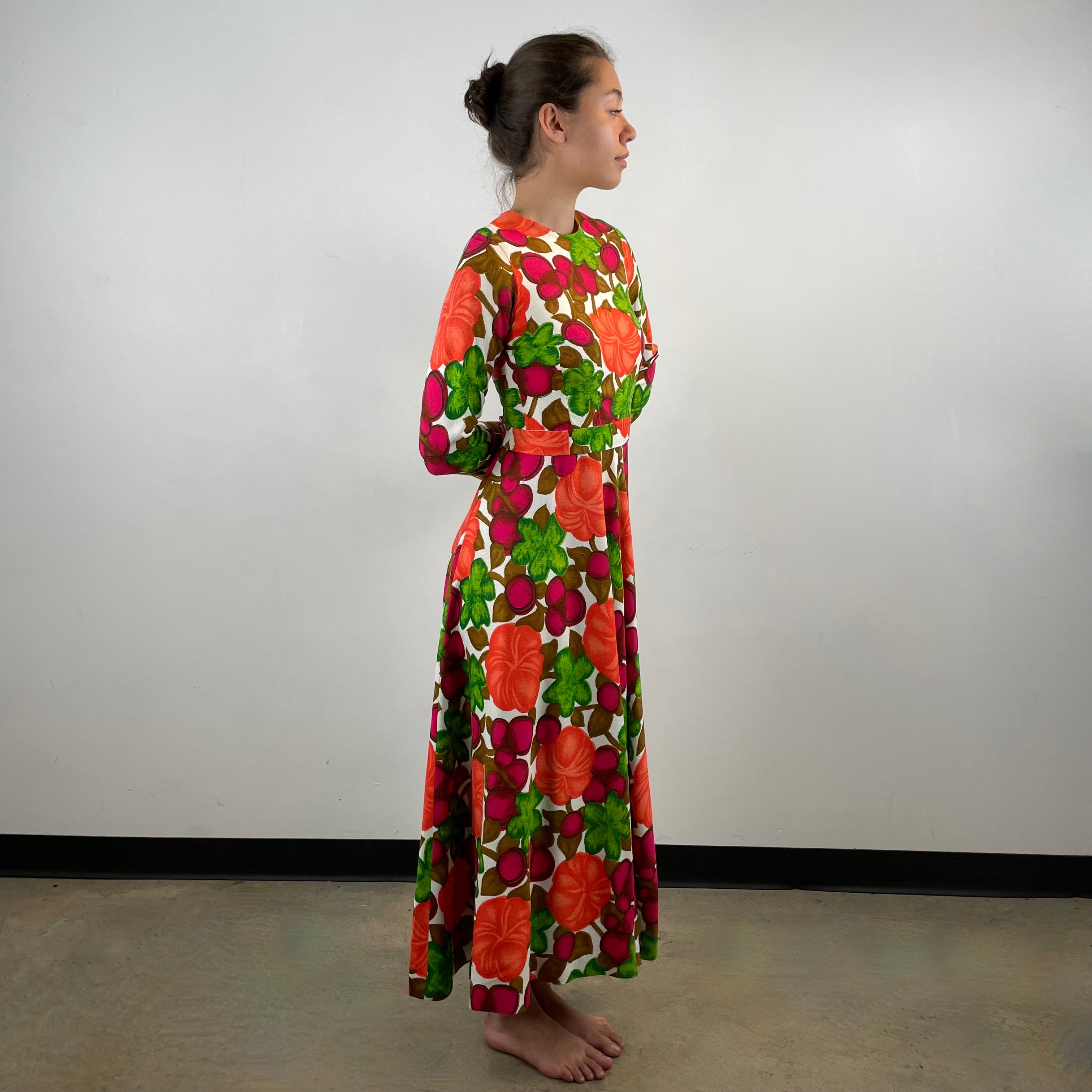 Vintage 1970s handmade long-sleeve dress in textured canvas-style fabric with bold artistic designs, fitted bodice, flared skirt and matching belt.
