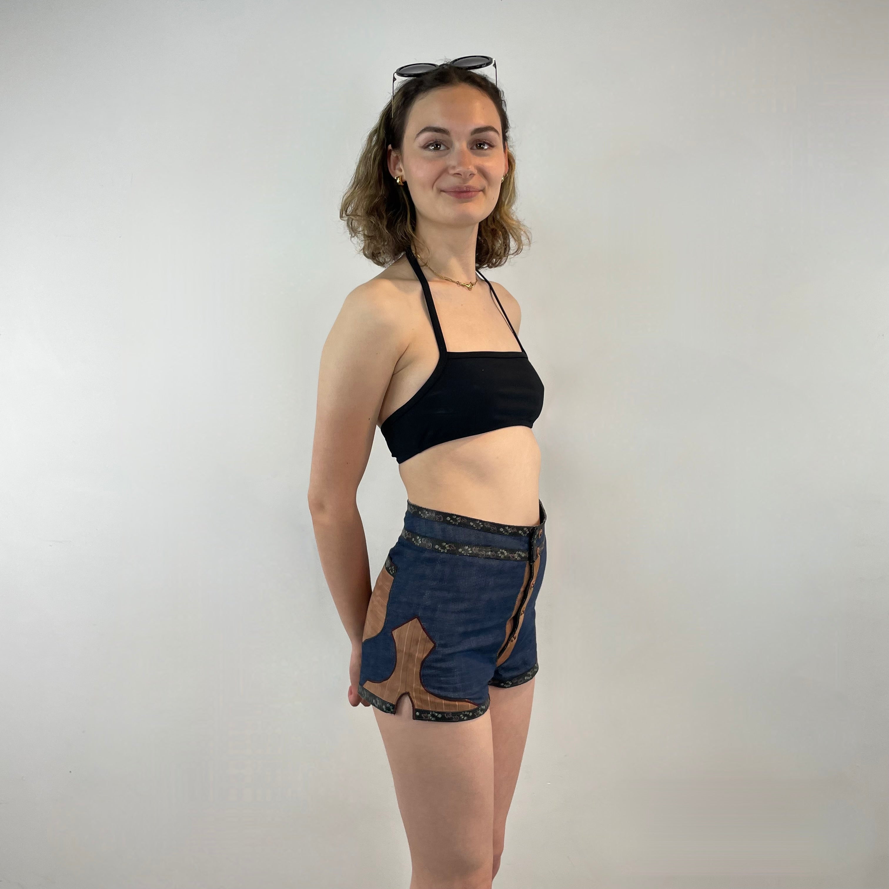 Boheme Vintage 1970s Roberto Cavalli denim and leather hot pants shorts with flower snap closures and leather appliqué details.