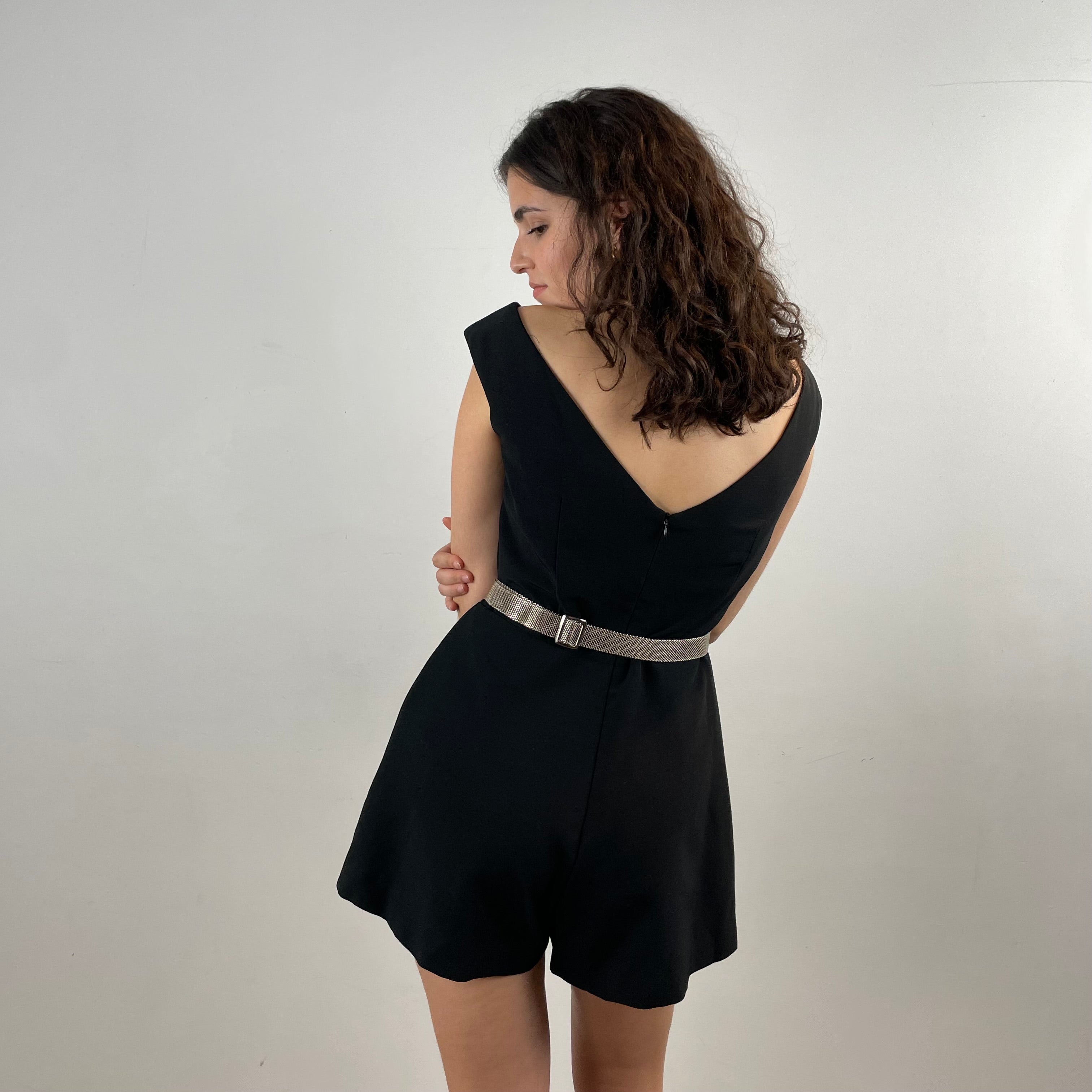 Back View of Boheme Vintage 1980s C’est Ma Mère Qui M’habille black romper with deep V neckline and flared shorts.