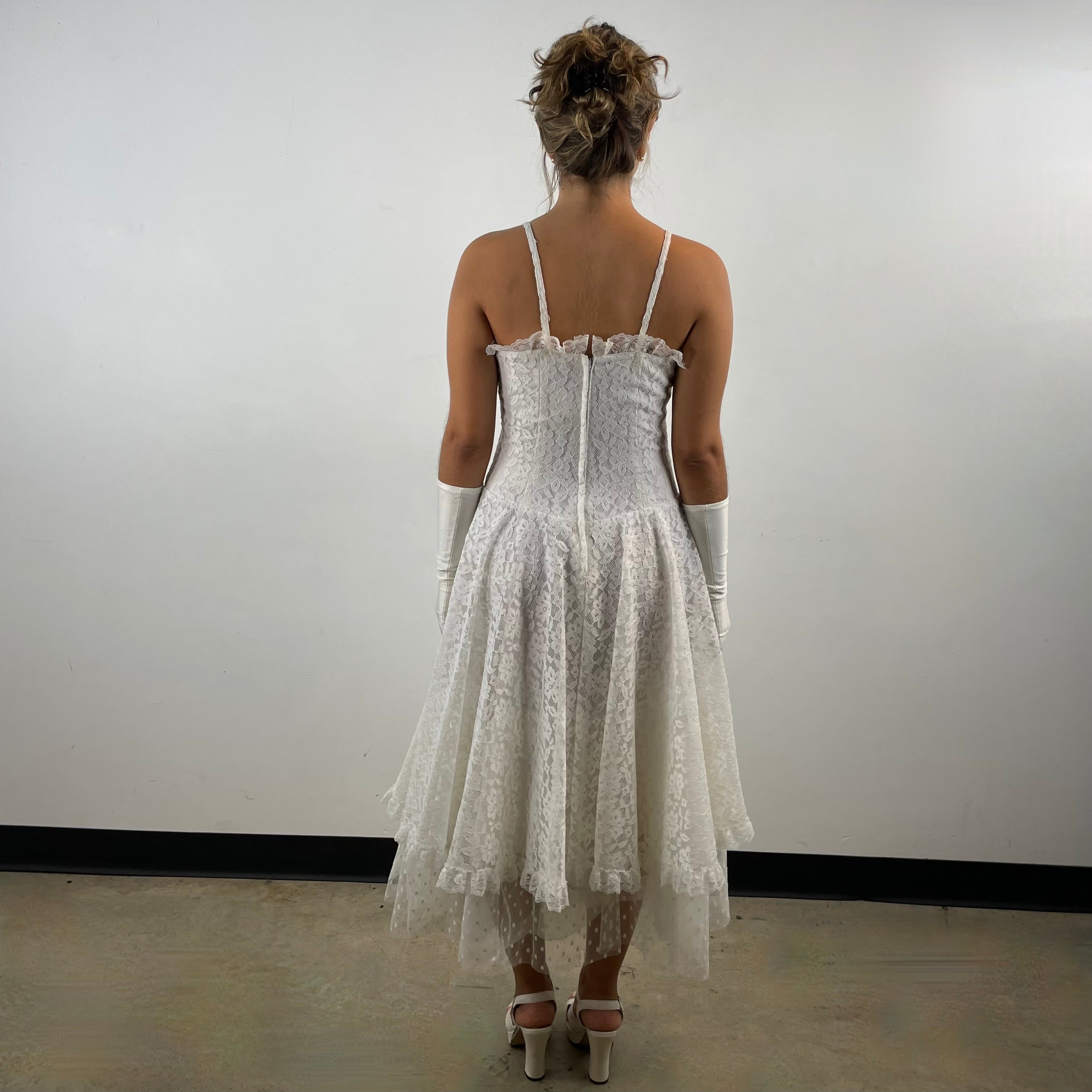 Boheme Vintage 1990s Algo Boutique white lace bustier dress with narrow straps, flared skirt, and layered tulle hem.