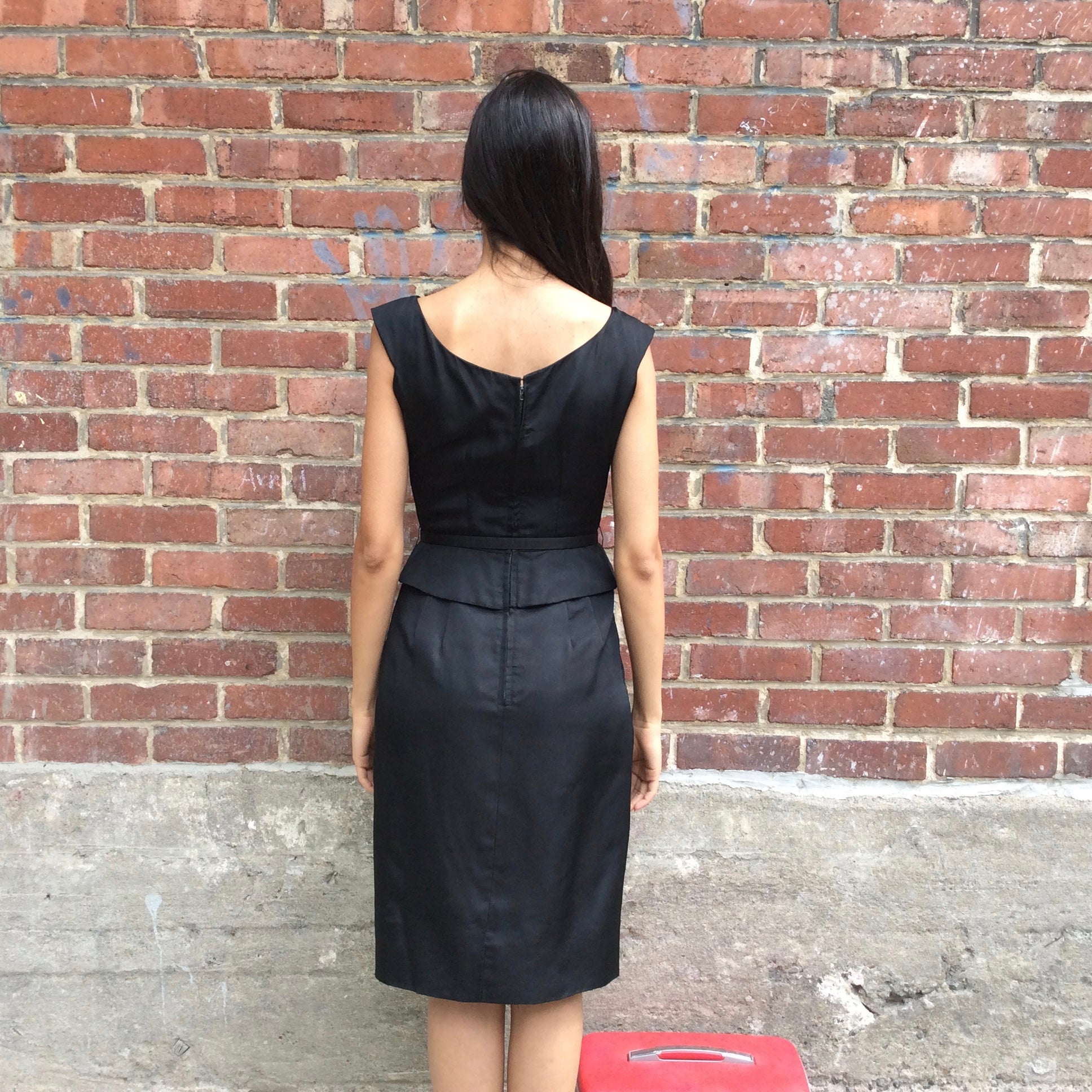 Back view of 1950s Black Dress With Peplum 
Size Extra-Small/Small 
Sold at bohemevintage.com
Montréal