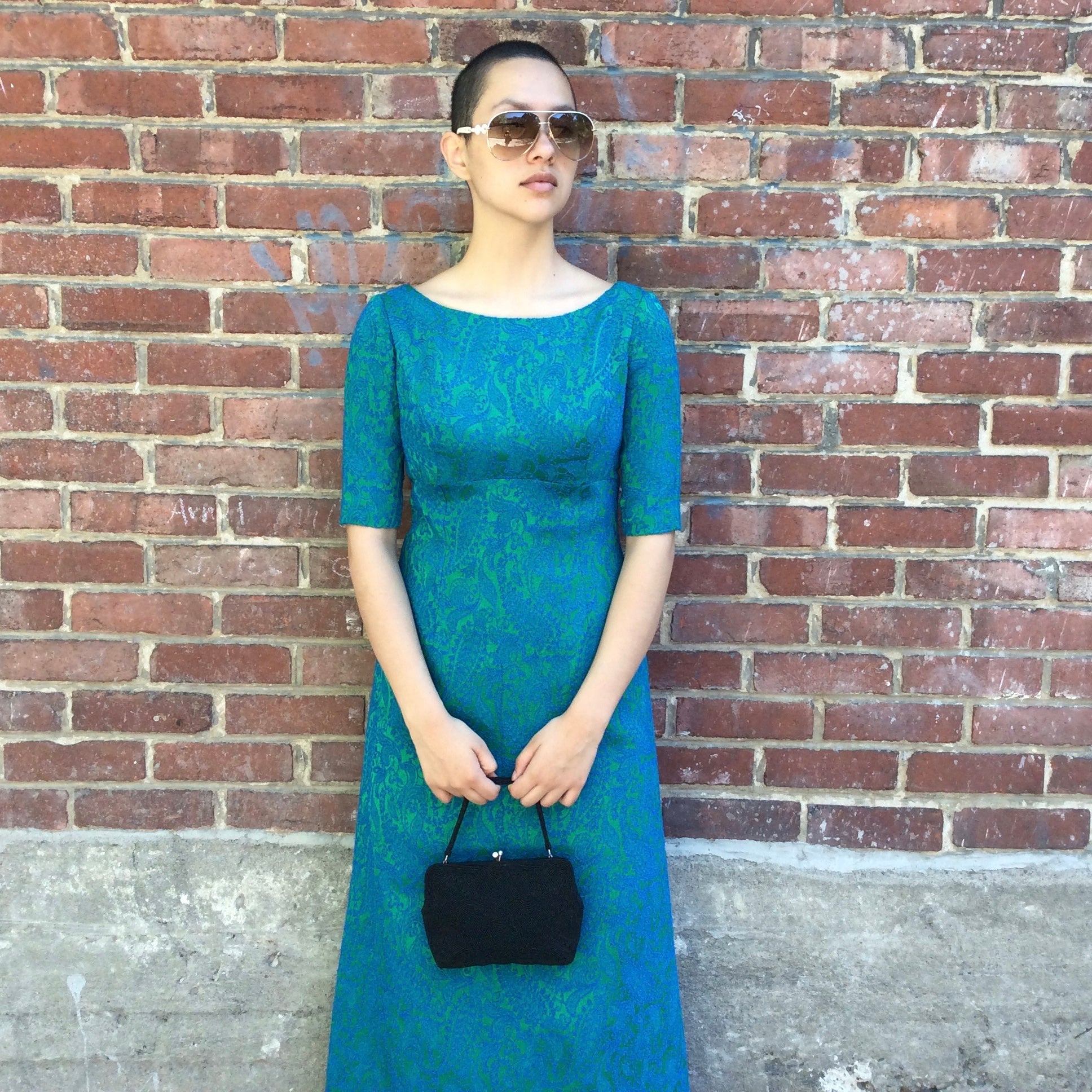 Vintage 1960s blue and green brocade ankle-length evening dress with empire waist and low back detail, photographed in Montreal for Boheme Vintage – https://bohemevintage.com
 – Montreal vintage fashion boutique.