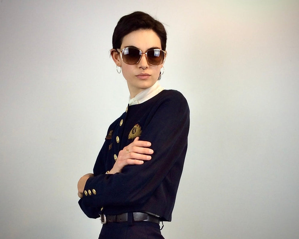 Model is wearing a 1980s cropped  navy blazer from Mondi with  1970s jabot collar blouse 