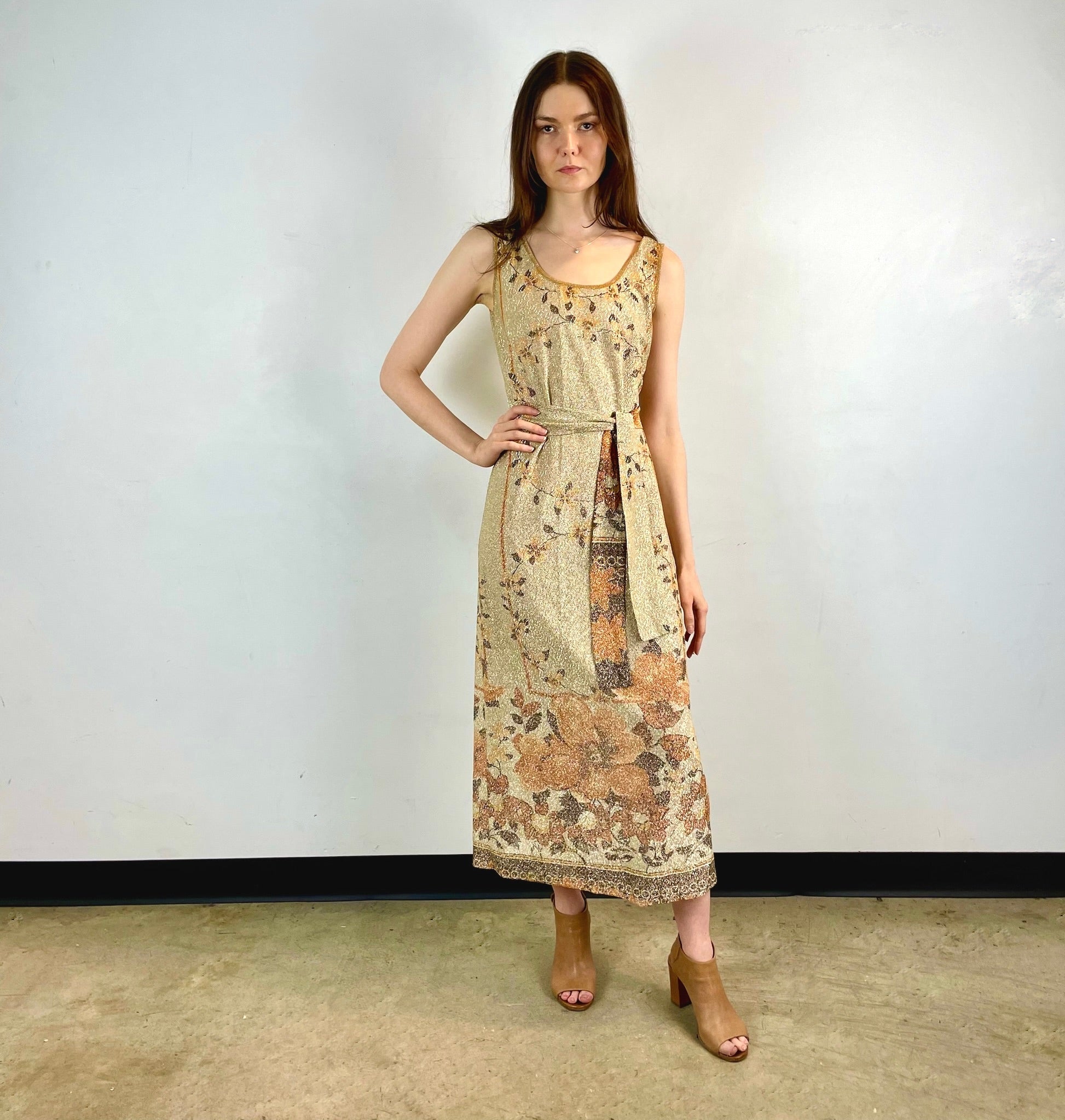 Boheme Vintage 1970s Le Petit Salon Dupuis gold Lurex maxi dress with sheer brocade fabric, sleeveless silhouette, and belt.