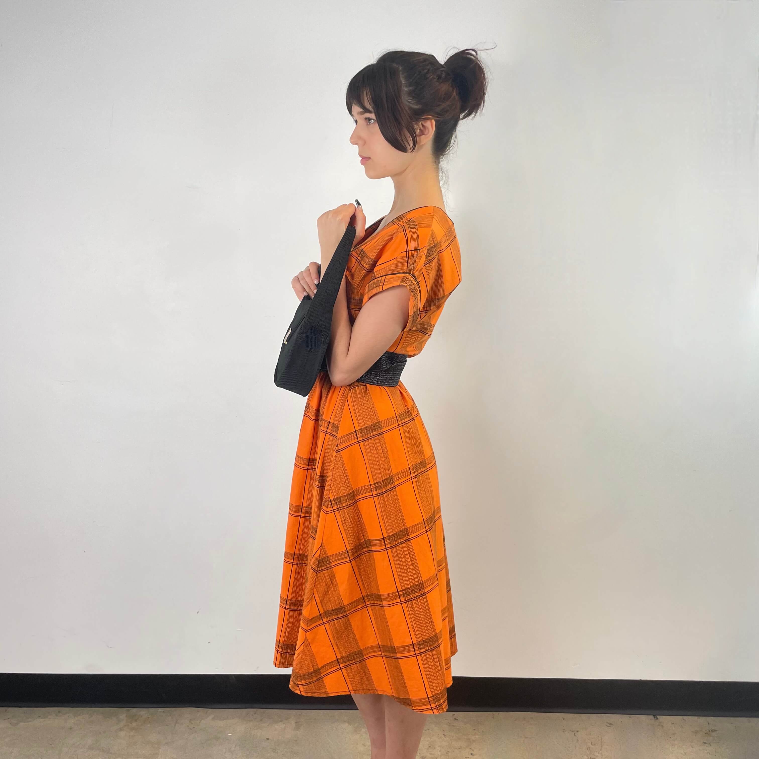 Side view of 1950s Orange Short Sleeve Buttoned-up Cotton Dress Size Small sold at bohemevintage.com Montreal