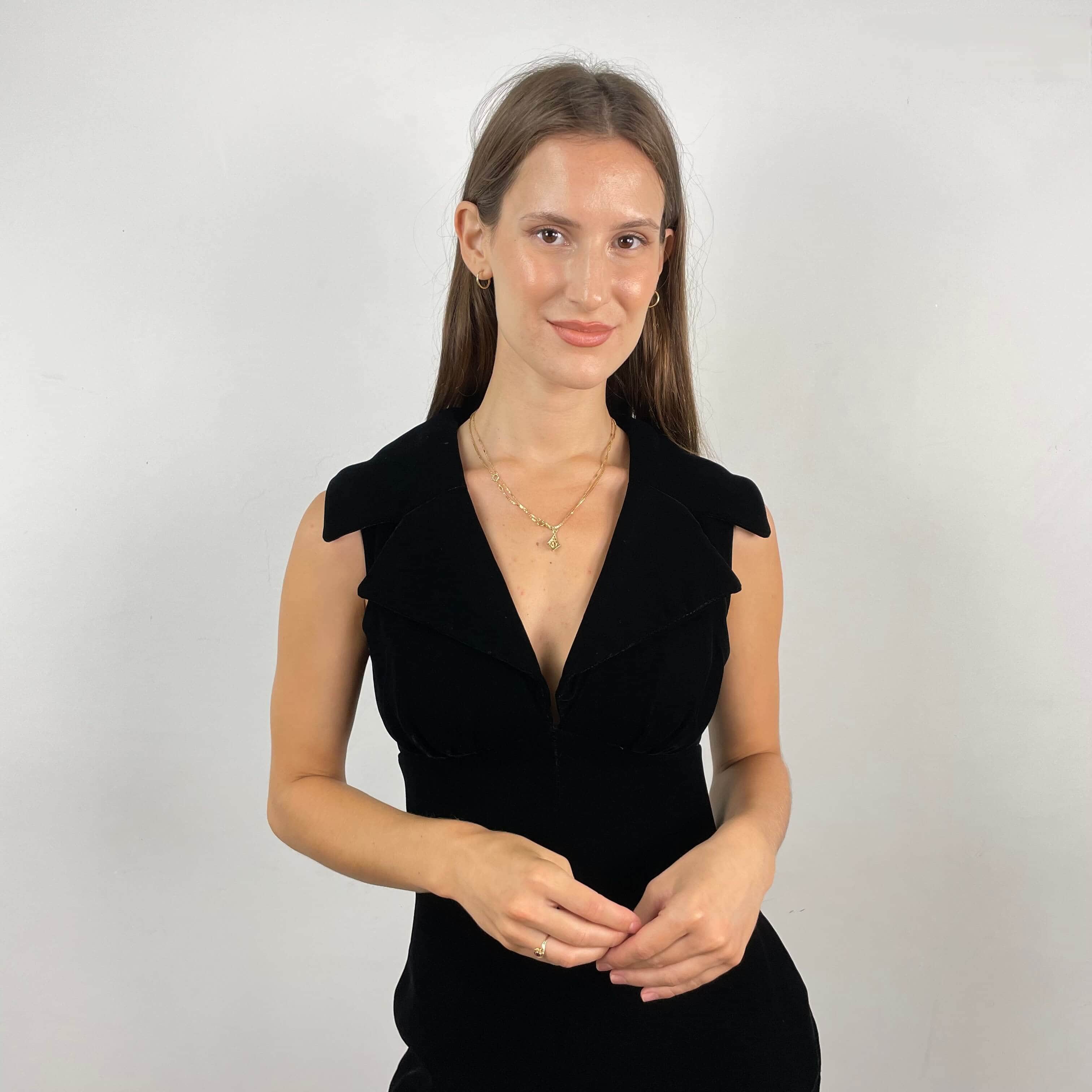 Close up view of plunging neckline of 1970s Deep V-Neck Black Velvet Midi Dress Size Small sold on bohemevintage.com Montreal