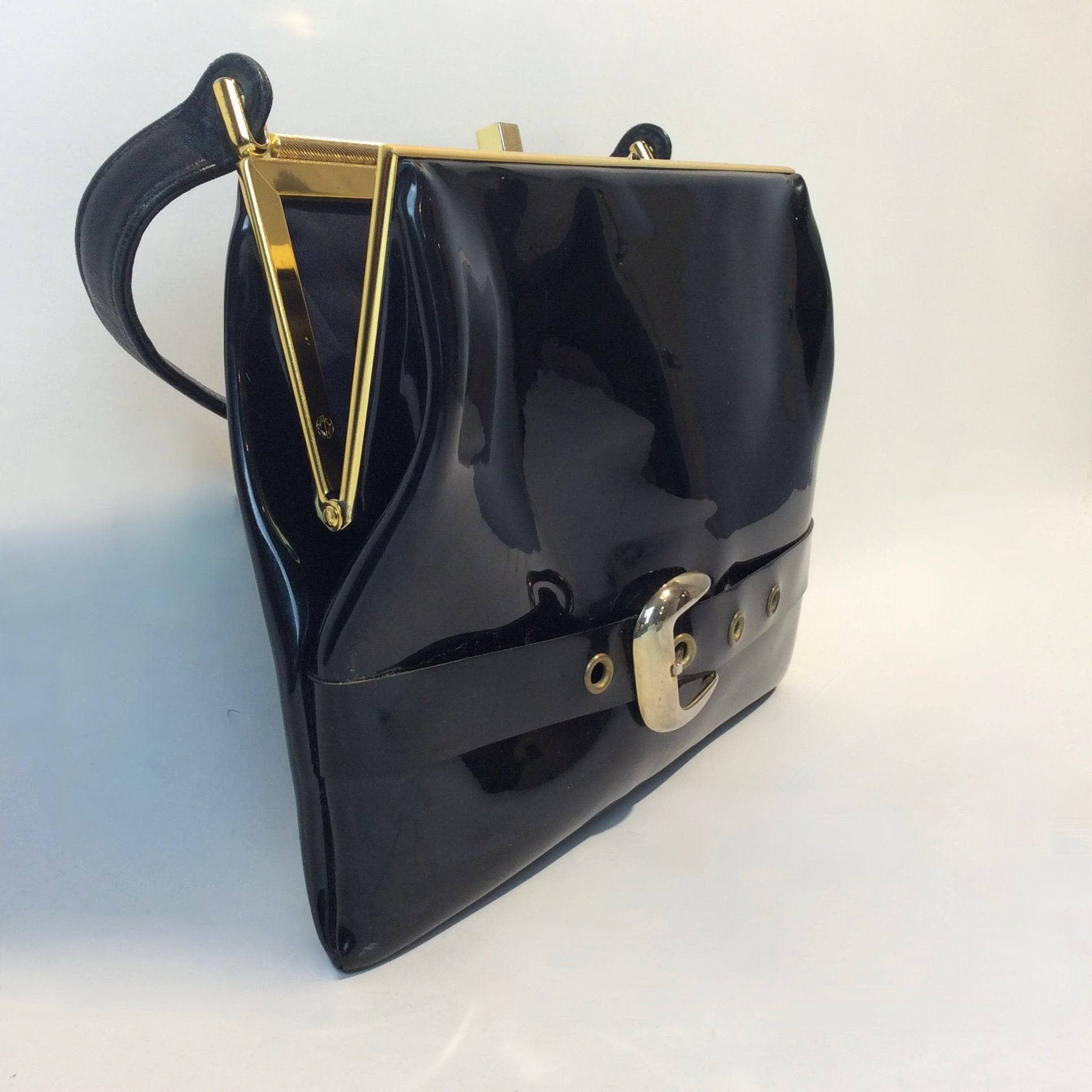 1950s-60s Black Patent Leather Handbag with Decorative Buckle Strap sold at bohemevintage.com Montreal