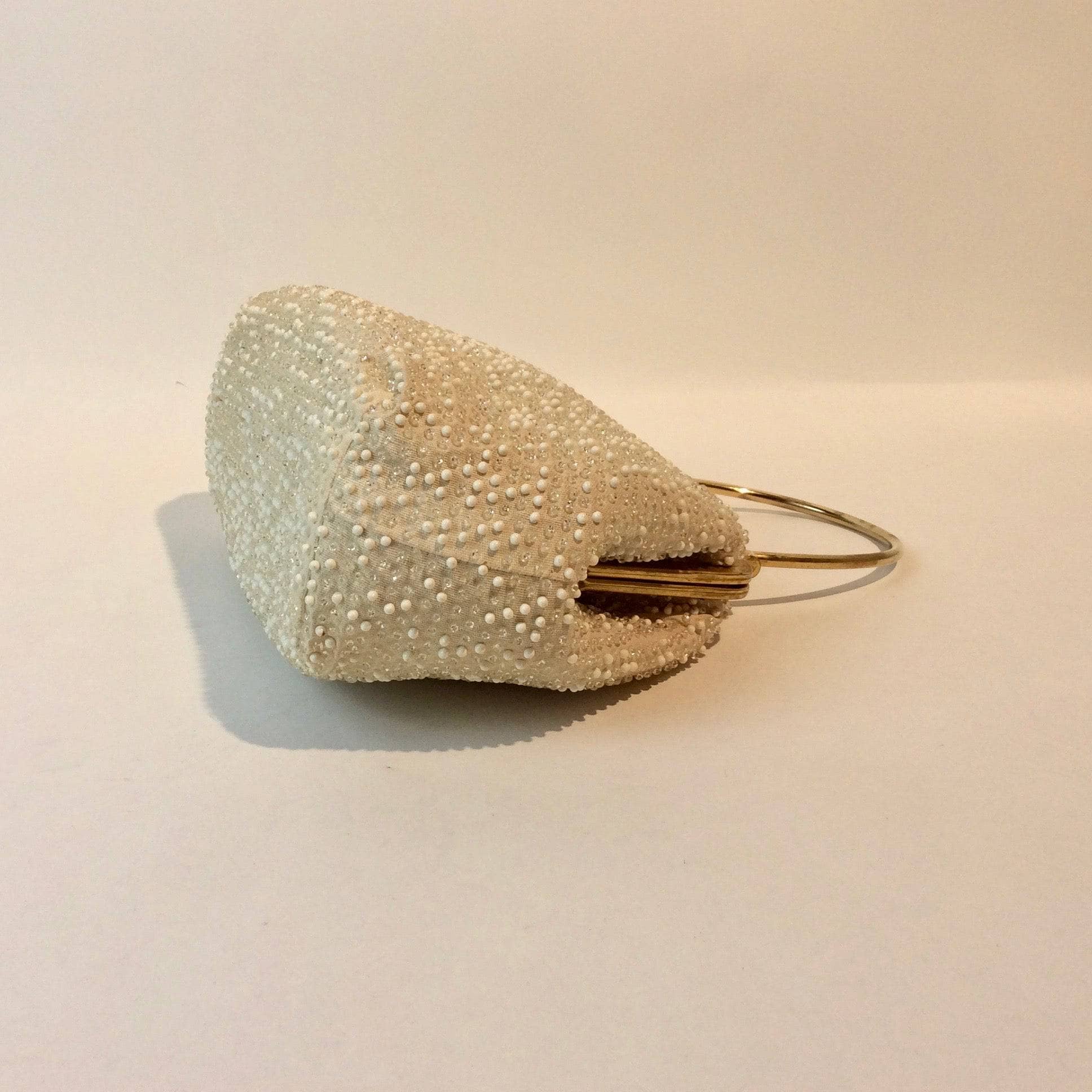 Bottom Side view of 1960s Cream Grandee Beaded Handbag with Brass Handle. Sold by bohemevintage.com Montréal