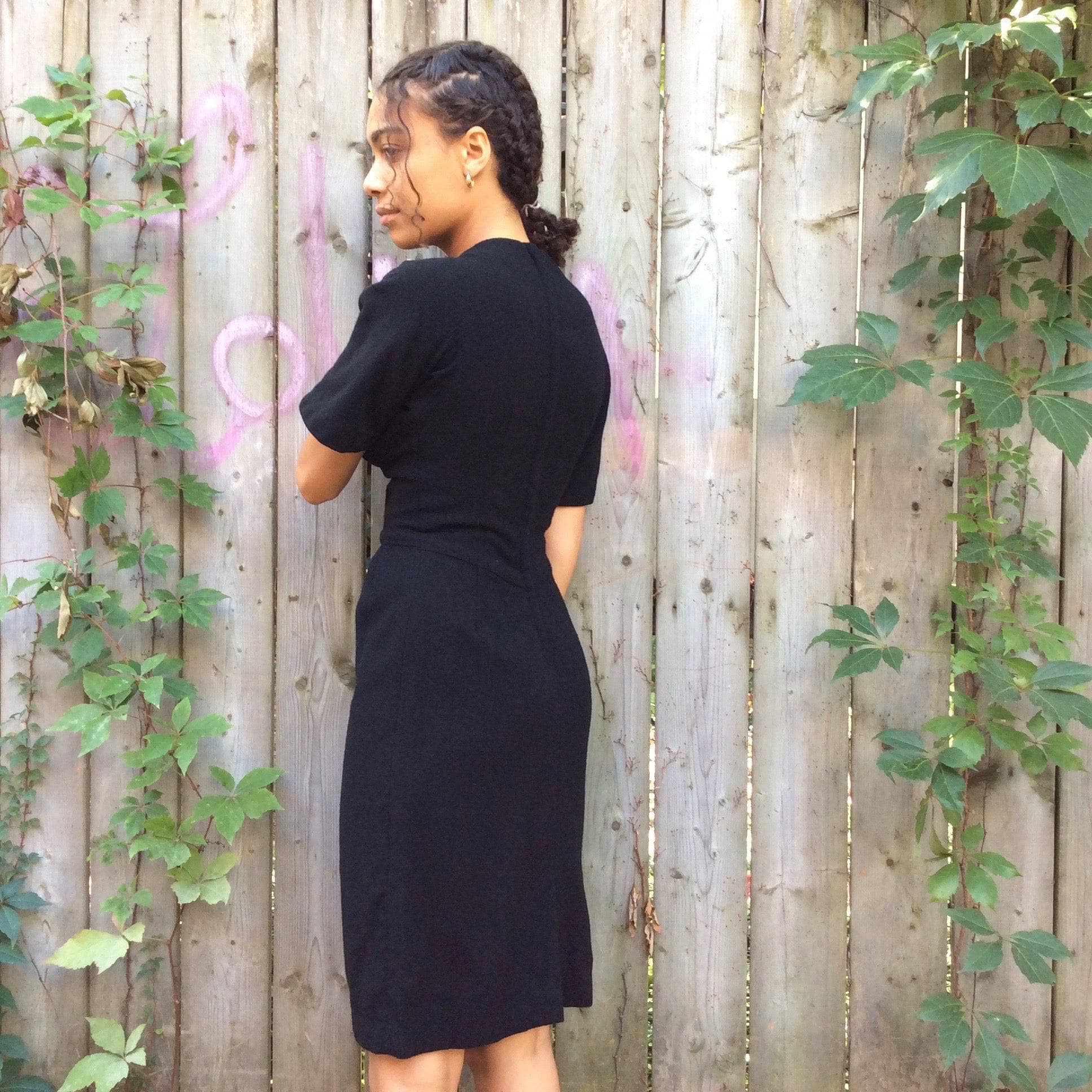 Back view of 1960s Short Sleeve Black Wool Dress Size Small sold by bohemevintage.com Montreal