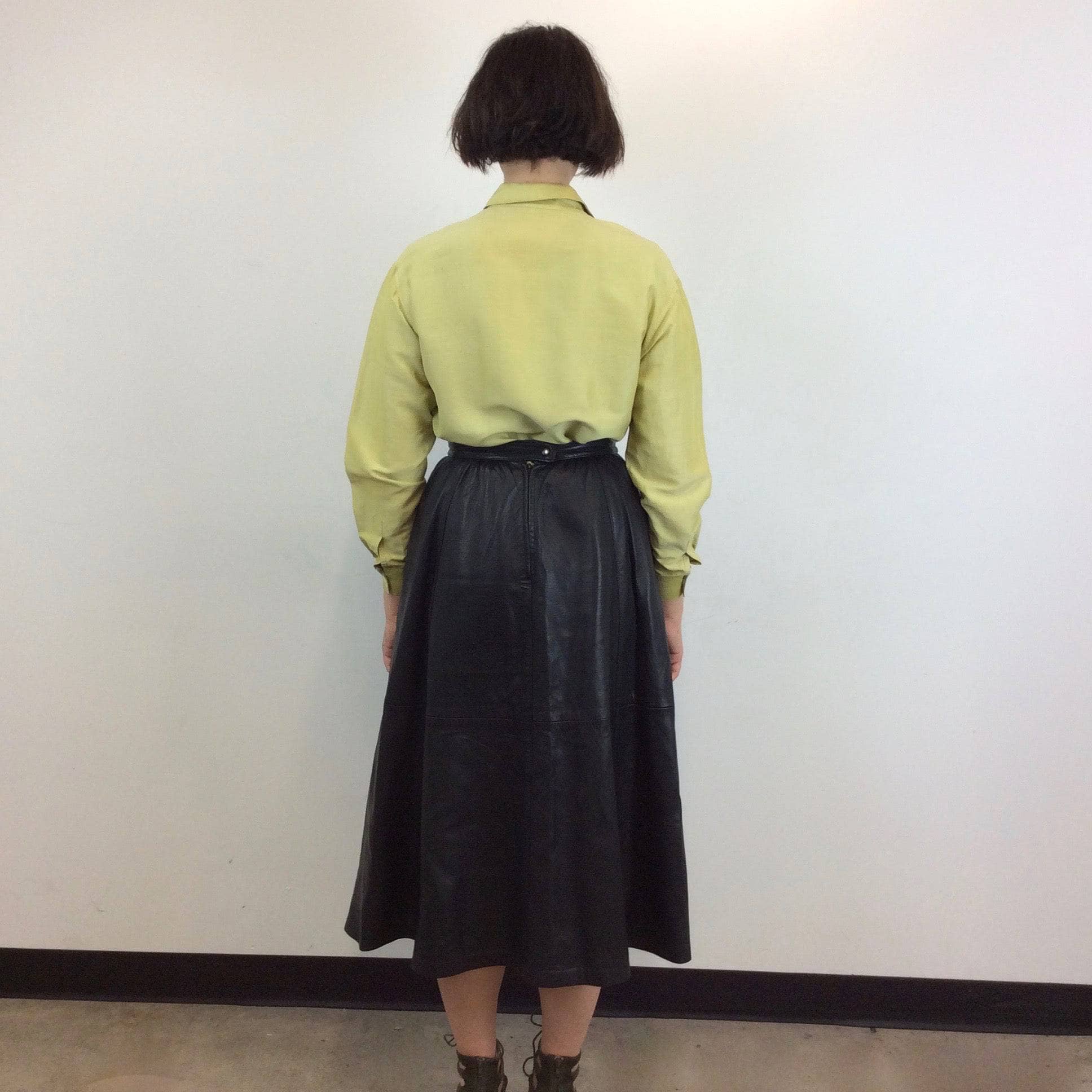 Back view of Flared Black Leather Midi Skirt Size Medium sold by bohemevintage.com