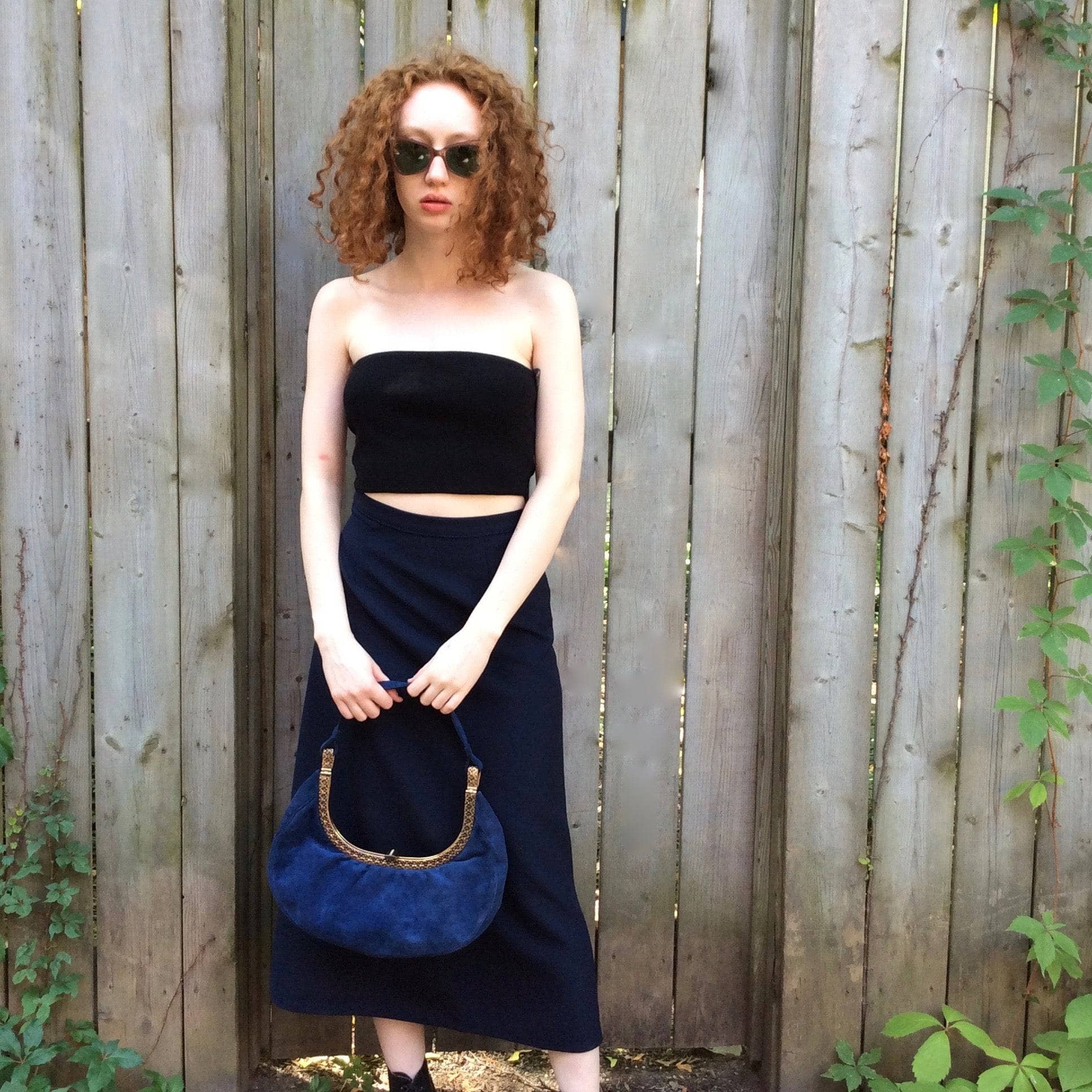 1950s Blue Suede Crescent Handbag with Detailed Gold Frame Koret Acc.  Model is wearing Navy Blue A-Line Skirt Sold at bohemevintage.com Montréal